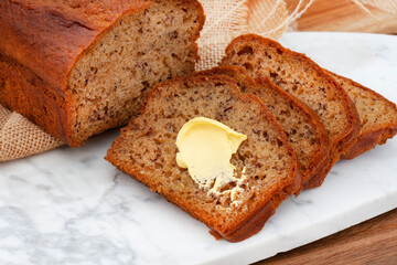 freshly baked rustic style banana bread loaf on country style table