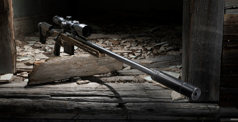Silencer on a bolt action rifle in a building