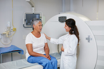 This is a totally noninvasive procedure. Shot of a senior woman being comforted by a doctor before and MRI scan.