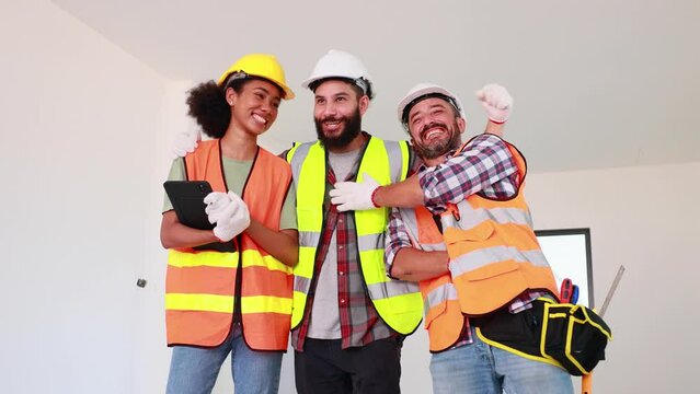 Slow motion VDO. 4K Professional Mechanical Engineer and construction team at house project underconstruction site. Hands meeting together in line. Unity and teamwork concept.
