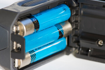 Recharged batteries in tourist headlamp, close up.