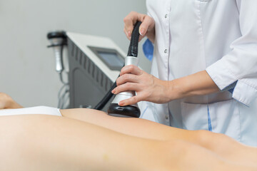 Slender woman receives a cavitation procedure getting anti-cellulite and anti-fat therapy on her...