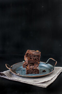 Brownie chocolate cake on the table, dark background