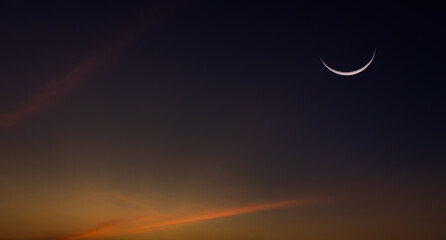Crescent moon on dusk sky twilight after sundown symbol of religion islamic in Ramadan Kareem month space for text Eid al Adha, Eid Al Fitr,  © Nature Peaceful 
