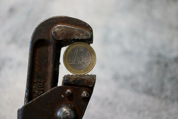 one euro coin in pincers - sanctions against russia from europe wallpaper