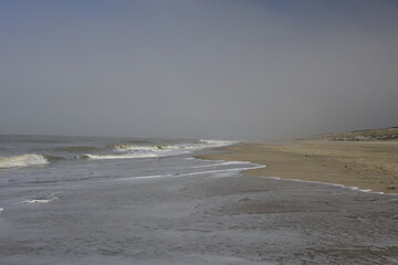 Beach at the Dutch North Sea coast on a hazy spring day with slightly blurred background (horizontal), Noordwijk, South Holland, Netherlands