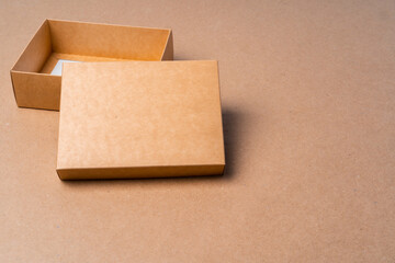 Cardboard box on beige background in studio