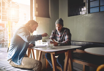 Have you seen this. Shot of two friends using a tablet while having coffee in a coffee shop.