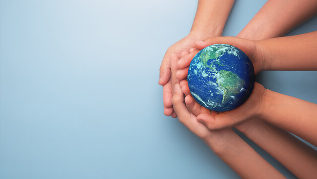 Group of Hands holding earth globe on blue background, International human solidarity day concept, world health day, safe world concept with copy space, Elements of this image furnished by NASA