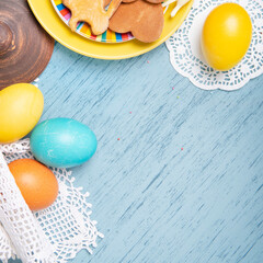 Easter background with colored eggs and holiday homemade cookies