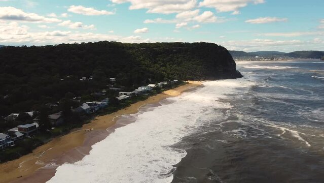 Drone aerial shot of housing along sandy beach in Pearl Beach rural town Umina Point Hawkesbury River Central Coast tourism NSW Australia 4K