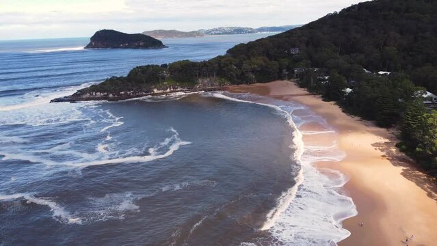 Drone aerial landscape shot of Lion Island Pearl Beach Palm Beach sandy beach swell waves Central Coast Hawkesbury River tourism NSW Australia 4K