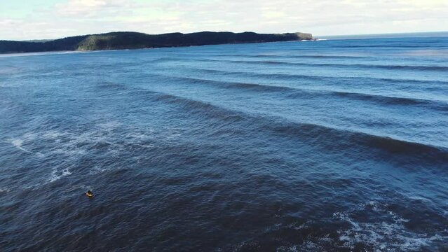 Drone aerial still shot of jet ski waiting Umina Point Pearl beach ocean waves swell lines Hawkesbury RIver Central Coast NSW Australia 4K