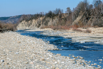 Mountain river in the mountains of Ukraine. Peremiyskaya river, Ivano-Frankivsk region. Spring 2022.