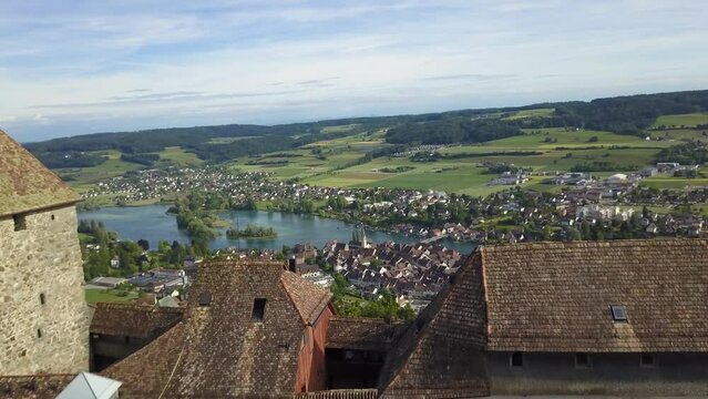 Aerial dolly in of Hohenklingen Castle revealing Stein am Rhein picturesque village and Rhine river in green valley, Switzerland