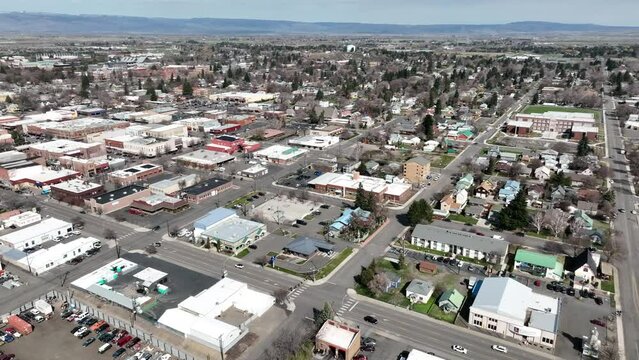 Cinematic 4K aerial drone pan shot of the commercial, business zone of the city of Ellensburg, Kittitas County in Western Washington