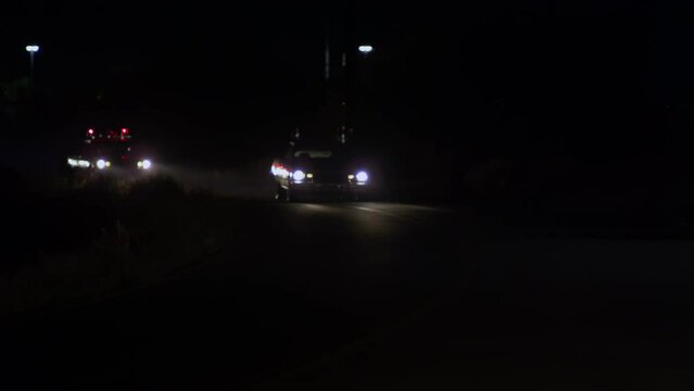 Old red Corvette being cut off of the road by police cars and taking off with speed.