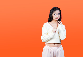 Contempt and disgust concept with young woman isolated on orange background.