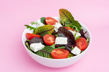 Greek salad of fresh cucumber, tomato, sweet pepper, lettuce, red onion, feta cheese and olives with olive oil. Healthy food, top view