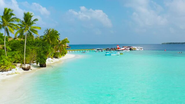 Water sport on Maldives with Colorful catamaran on azure water.