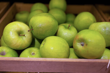 Apples in the basket at supermarket. Concept of organic and healthy food consumption