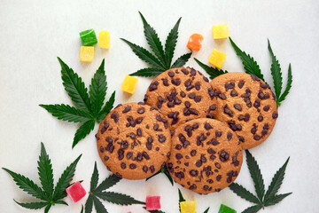 American cookies with cannabis extract. Sweets with CBD oil. Marijuana leaves on white background....