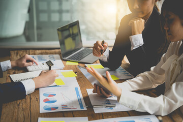 Managers are using report to analyze sales cost reports and explain summary reports to employees calculate and record summary information data in the office.