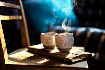 Coffee Served in Handmade Ceramic cups with steam on morning light