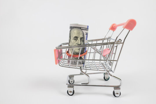 image of trolley cart with bank note isolated in white background with copy space.