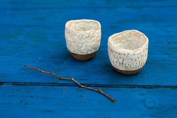 Ceramic tea cups on blue dining table