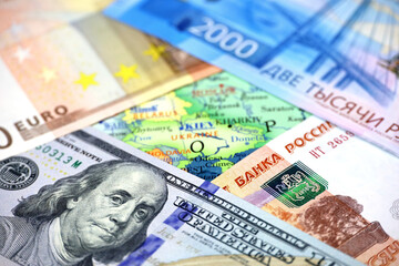 US dollars, Russian rubles and Euro currency on map of Ukraine. Concept of american and european support for Kiev during special military operation of Russia