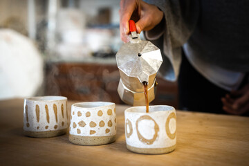 Serving Coffee into Handmade Ceramic Art cups