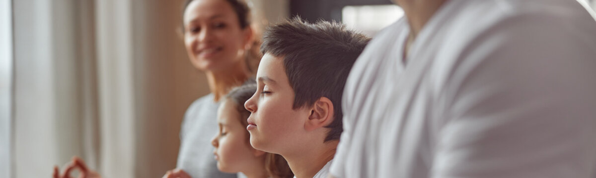 Cropped Head Of Smiling Woman Watching Her Husband And Kids Doing Mental Practice At Home Together