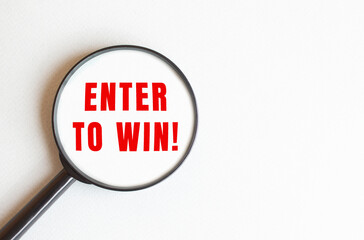 The text ENTER TO WIN is written on a gray background. We read through a magnifying glass.