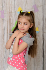 A child iin the interior with a festive decor. Easter day.