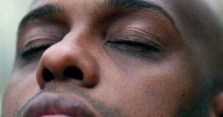 African man closing in meditation and contemplation, close-up black ethnicity eyes