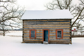 Log Cabin in the Snow with the front door open. - obrazy, fototapety, plakaty
