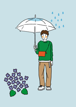 雨で憂鬱な気分の傘をさす若い男性