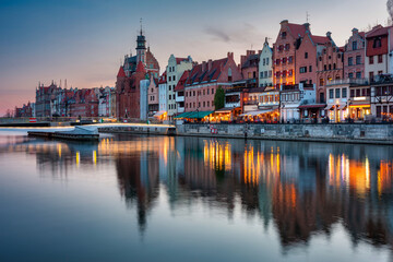 Fototapeta na wymiar Beautiful architecture of Gdansk old town reflected in the Motlawa river at dusk, Poland