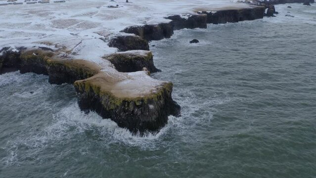 Ocean Waves Hitting The Rocky Cliff And Coastline Of Arnarstapi In Iceland. - aerial