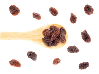 Raisin in spoon and bunch isolated on white background. Macro. Healthy food concept