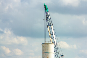 Obraz premium Large white water tank with blue sky.