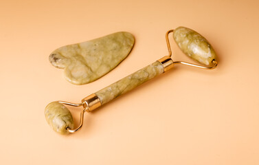 Gua Sha massage tools. Jade scraper and roller. Facial beauty and skin health concept. Body care at...