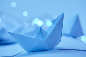 business concept- paper boats on the paper