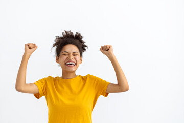 Portrait of funny young African American woman celebrating victory on a white background