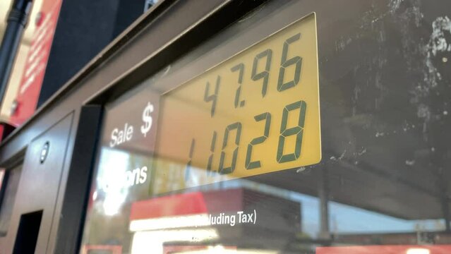 Gas prices close to five dollars a gallon add up quickly at fuel pump, close up point of view.
