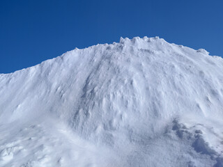 Hill of Snow Against Winter Sky