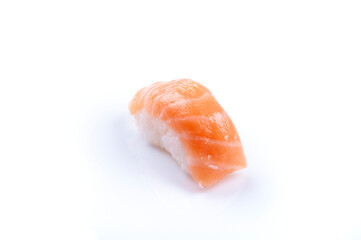 a piece of raw salmon nigiri sushi with rice japanese food close-up sliced ​​isolated on white background