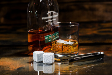 glass of scotch whiskey and cooling cubes