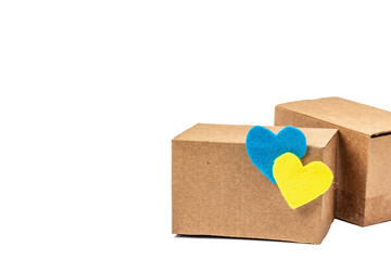 The concept of helping Ukraine in the war. Boxes with hearts in the colors of the Ukrainian flag